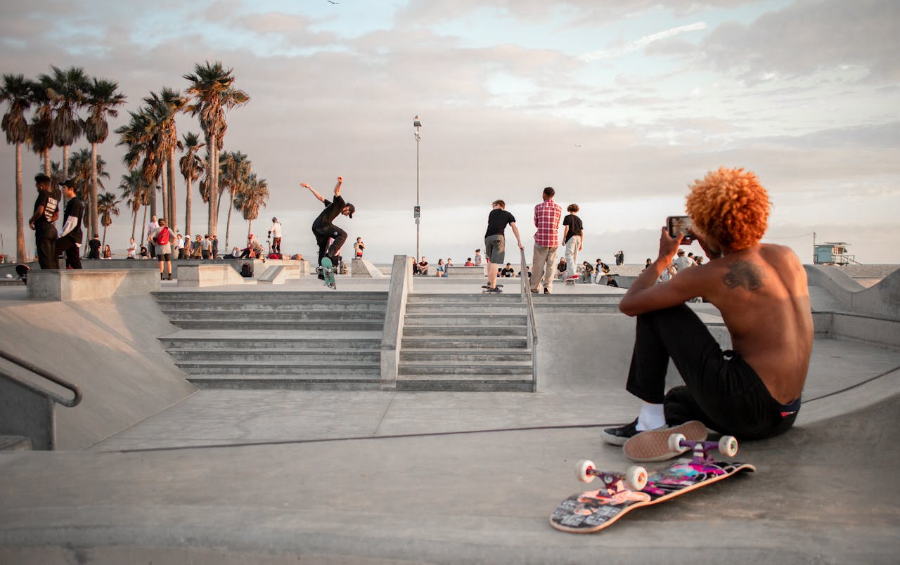 Energetic skateboarding action during sunset at Venice Beach Skatepark, Los Angeles.